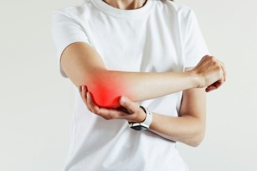 Arm pain and injury for woman. Closeup side body with painful elbow Arm pain and injury for woman. Closeup side body with painful elbow
