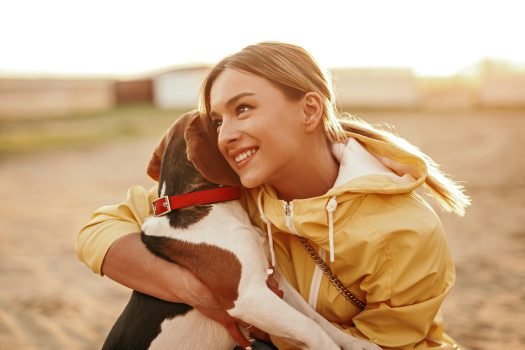 Cheerful lady hugging dog and smiling Cheerful lady hugging dog and smiling